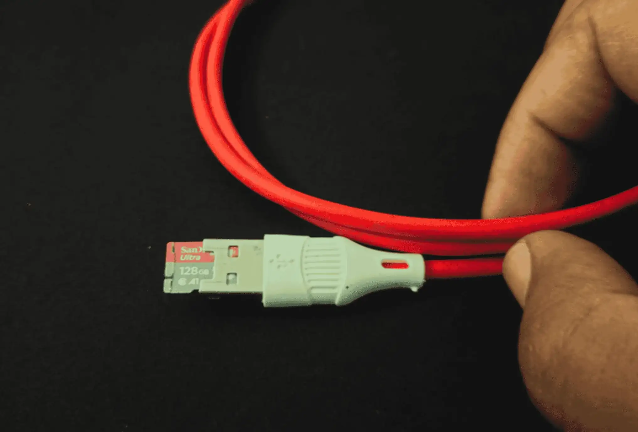 Red USB cable with hidden ESP32-S3 microcontroller and microSD slot inside connector